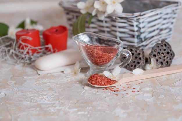 Pink and red salt, spa skin care, soap and towel, scented candles