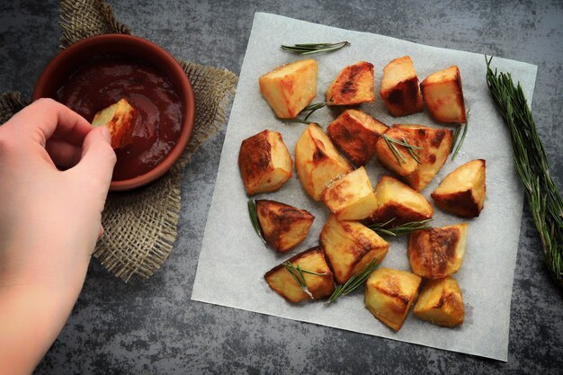 Baked potatoes on paper with rosemary and sea salt
