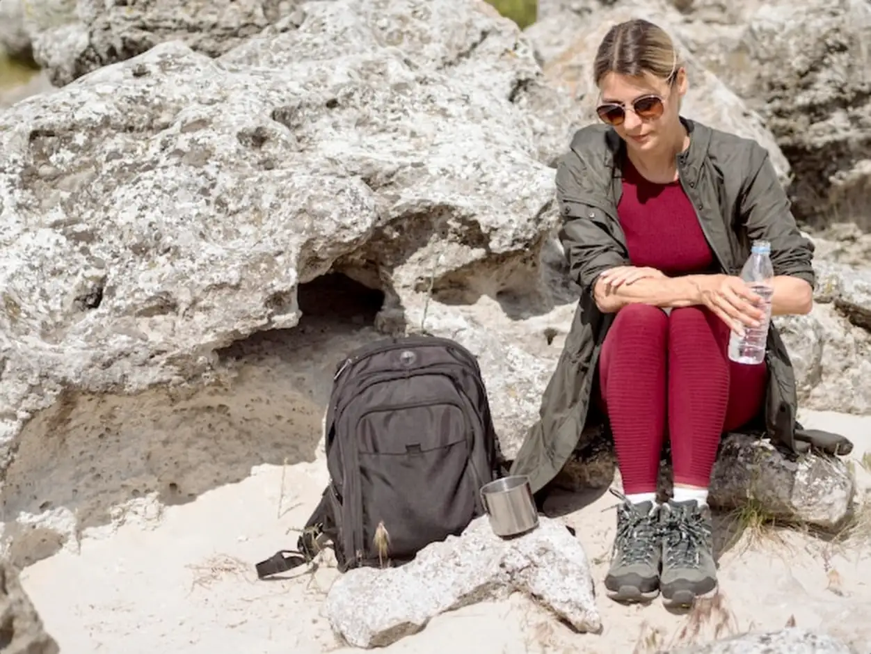 Traveling woman hydrating with water