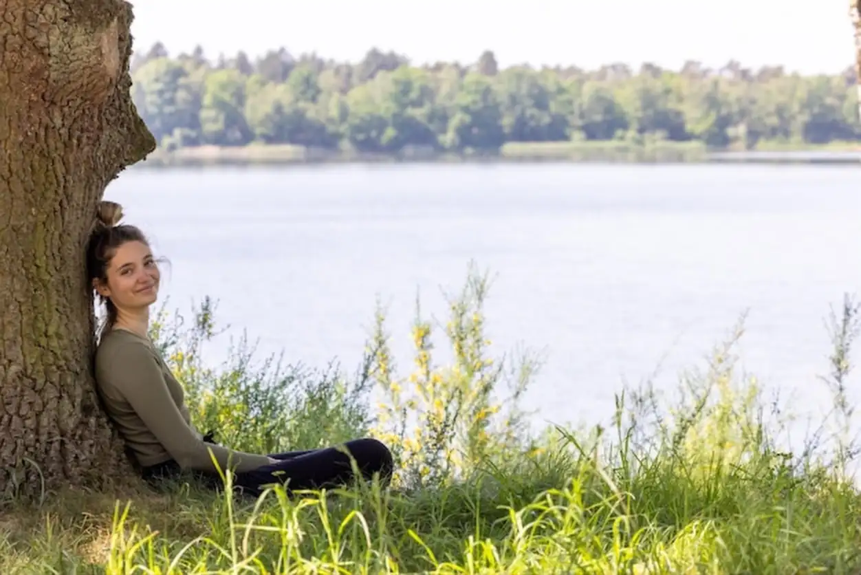 Side view of woman sitting on field