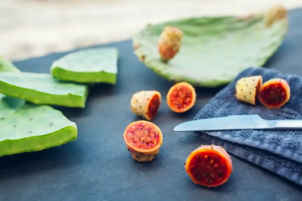 Prickly pear or cactus fruit cut with leaves.