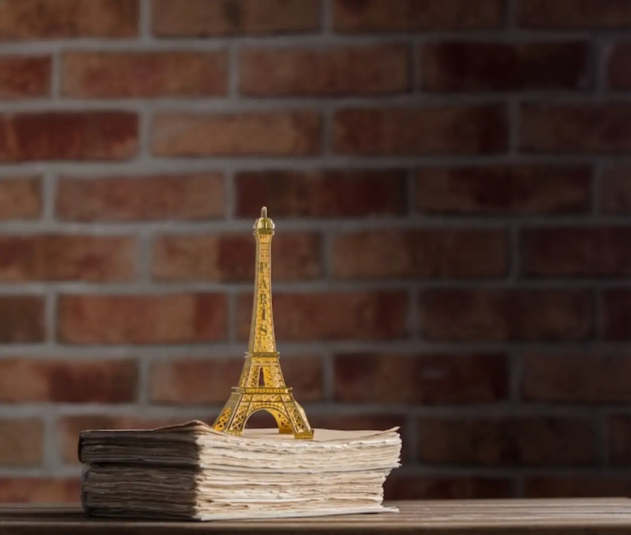 Golden Eiffel tower souvenir and old books