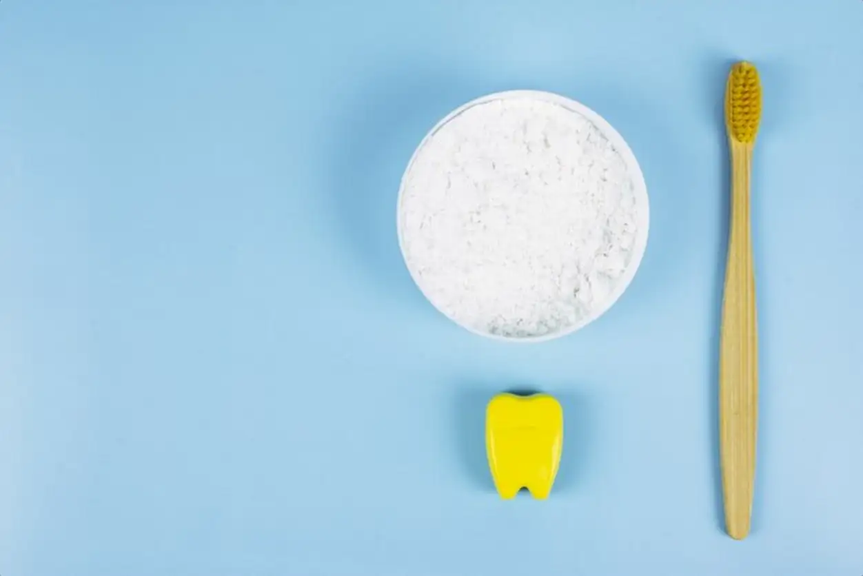 Toothbrush and dental floss and dental powder on a blue background. Oral care concept. Caring for nature, zero waste. Copyspace