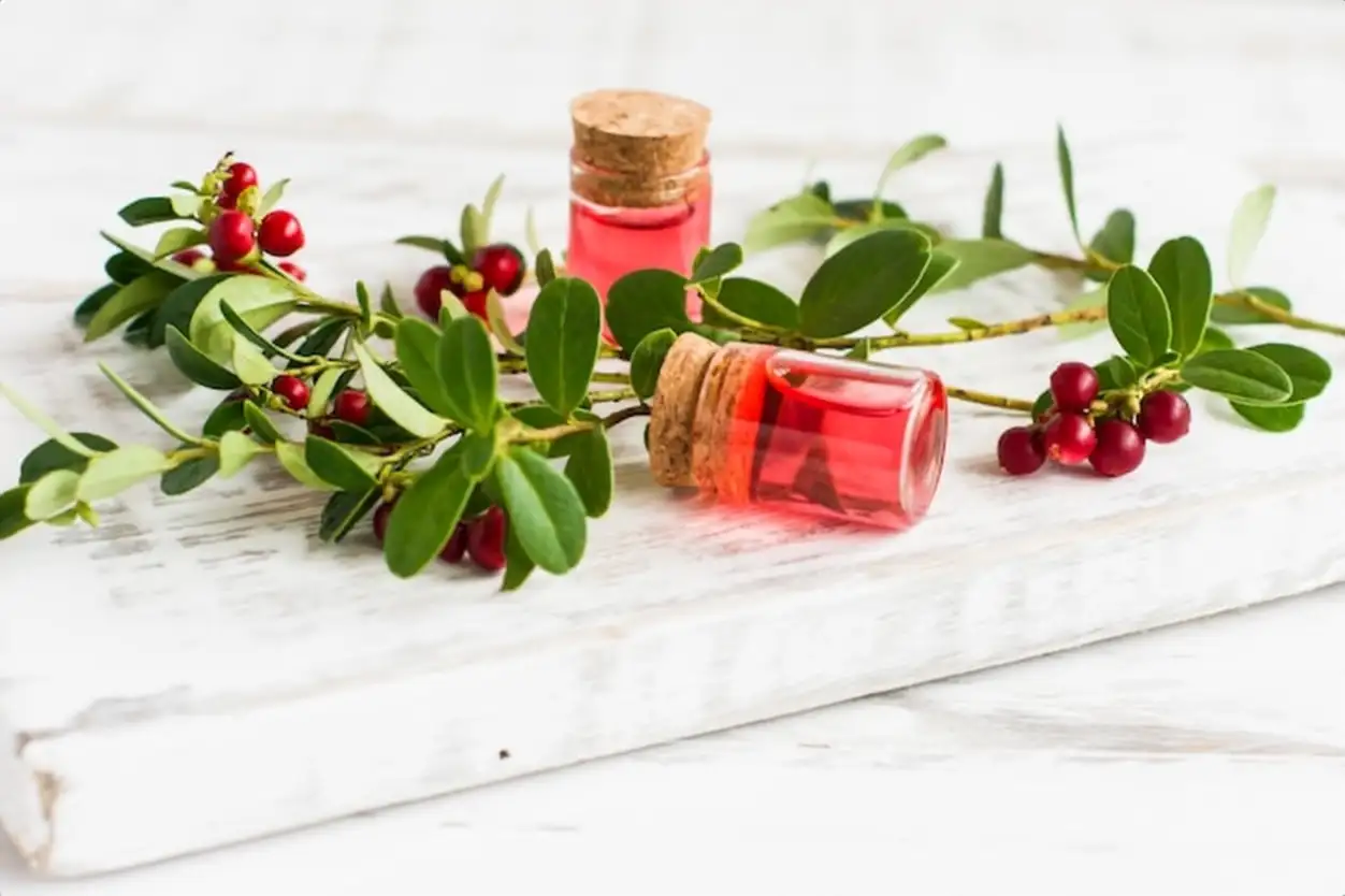 Moisturizing oil-fluid for the face with extract of viburnum berries. vitamin E. white wooden podium. Selective focus