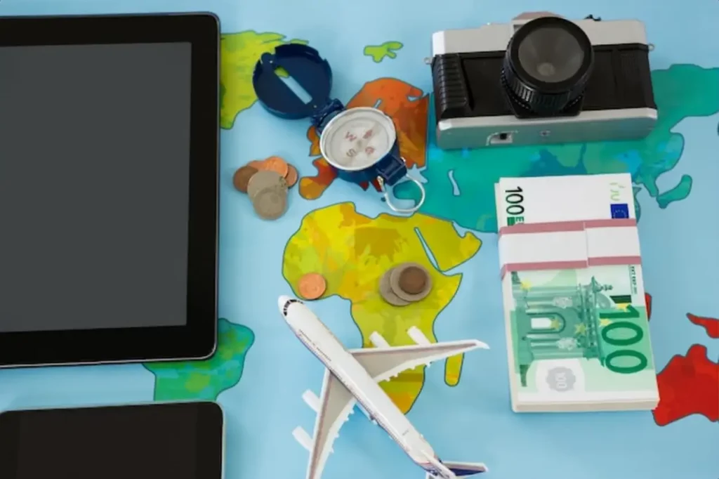 Electronic gadgets, camera, dollar, compass, and airplane model