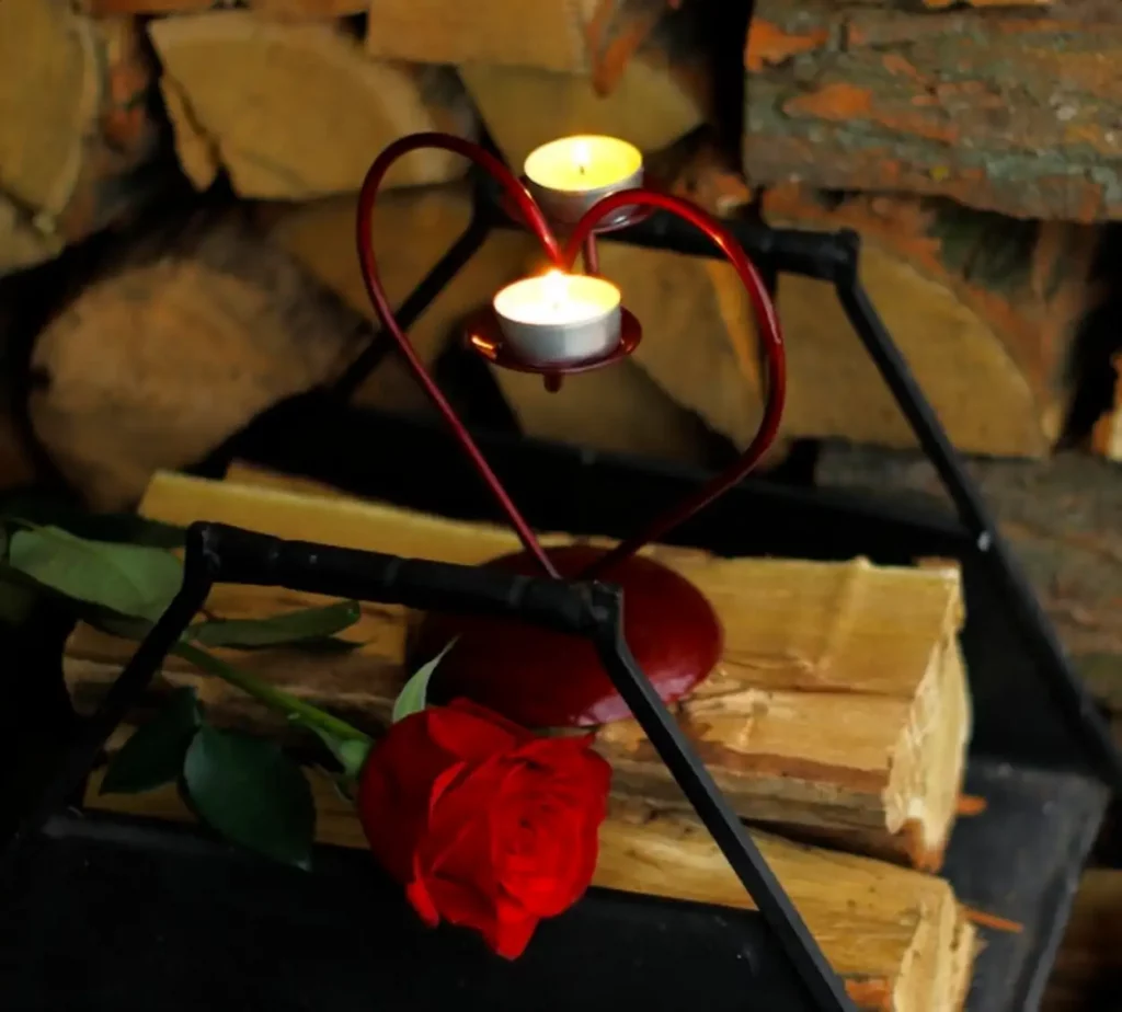 Tea light candles on heart shaped holder with red rose