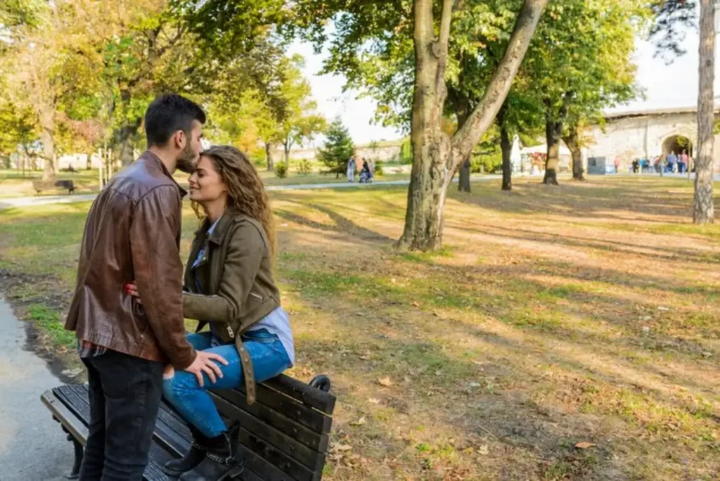 Young man kissing her girlfriends forehead