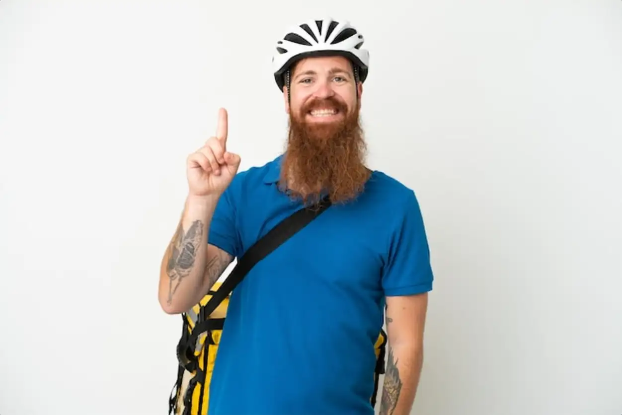 Young reddish caucasian man with thermal backpack isolate don white background showing and lifting a finger in sign of the best
