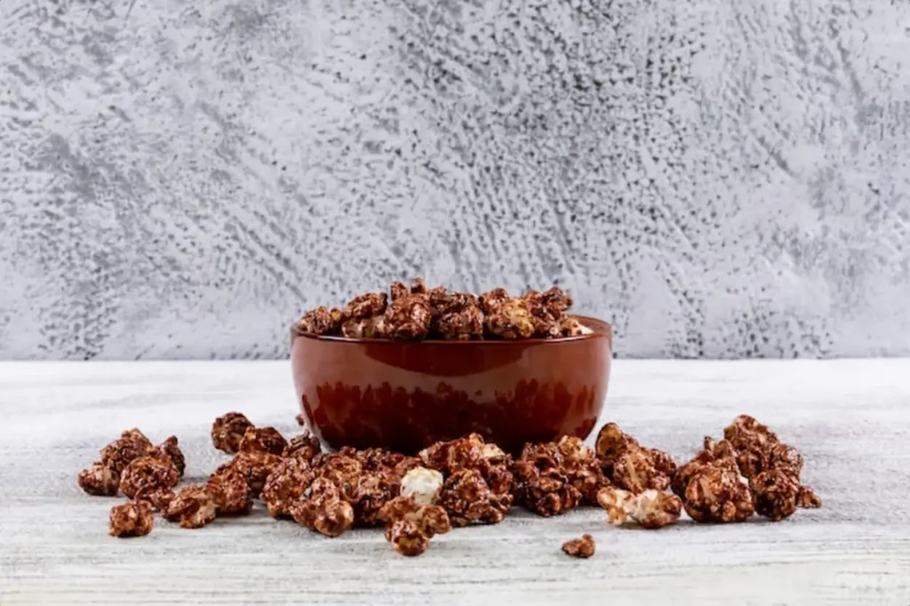 Side view of popcorn in bowl on white wooden table horizontal