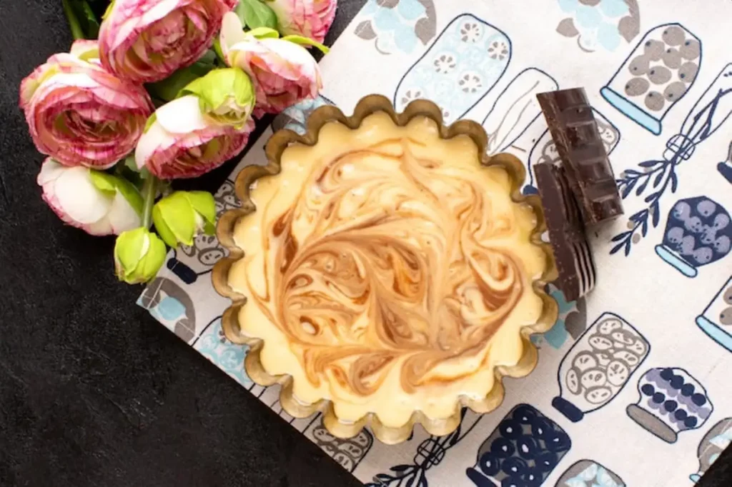 A top view delicious coffee cake sweet chocolate delicious sugar bakery cake sweet along with roses on the dark desk
