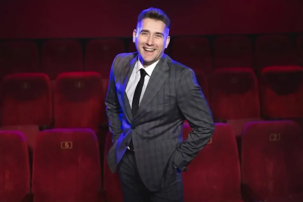 Portrait of a young handsome man alone in a movie theater