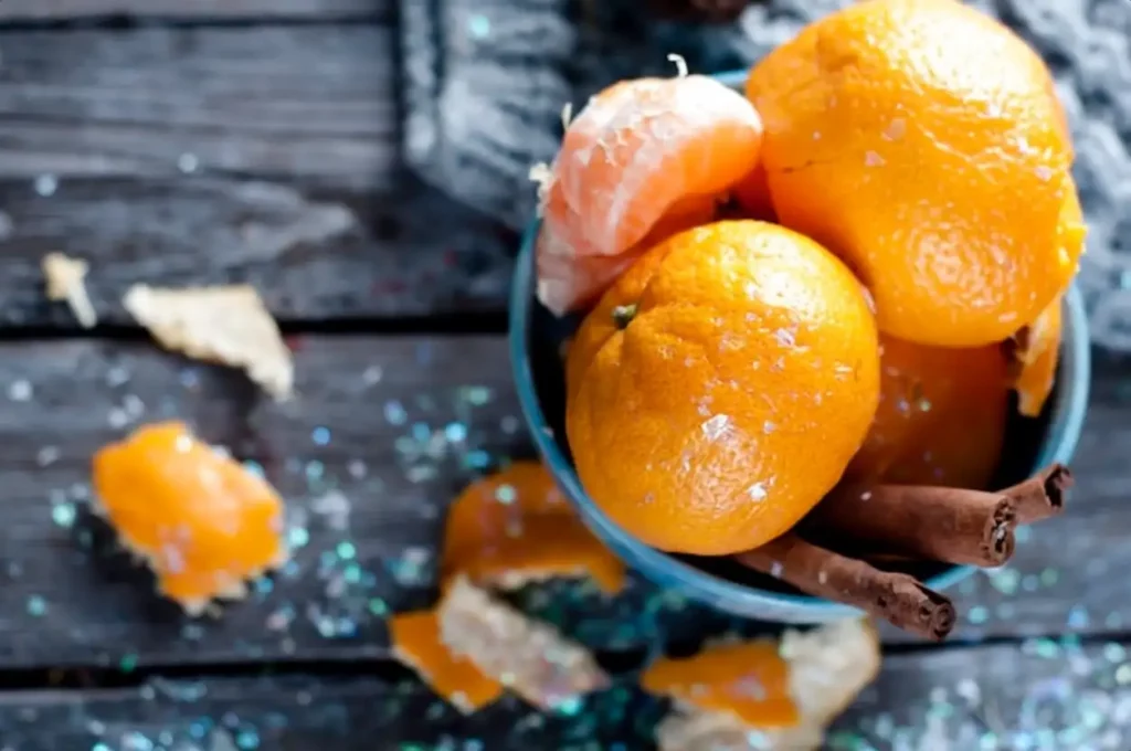 Tangerine in scarf over wooden background
