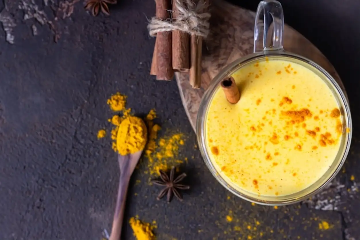 Golden milk or latte with turmeric powder with spices