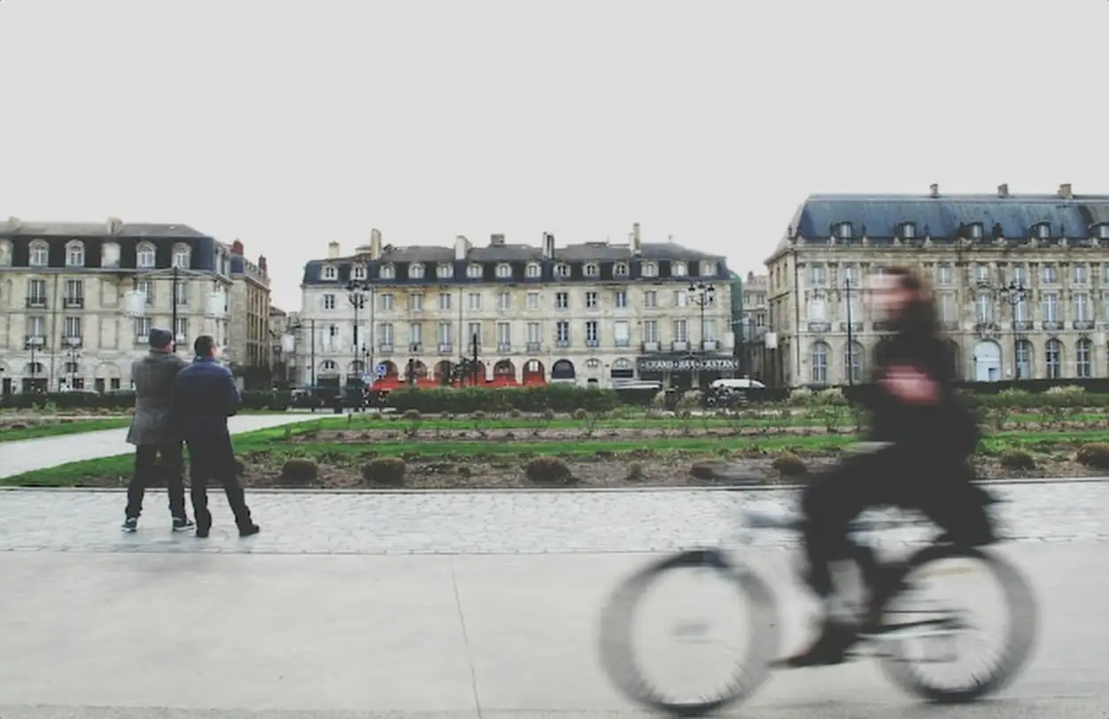 Blurred motion of man riding bicycle on city street