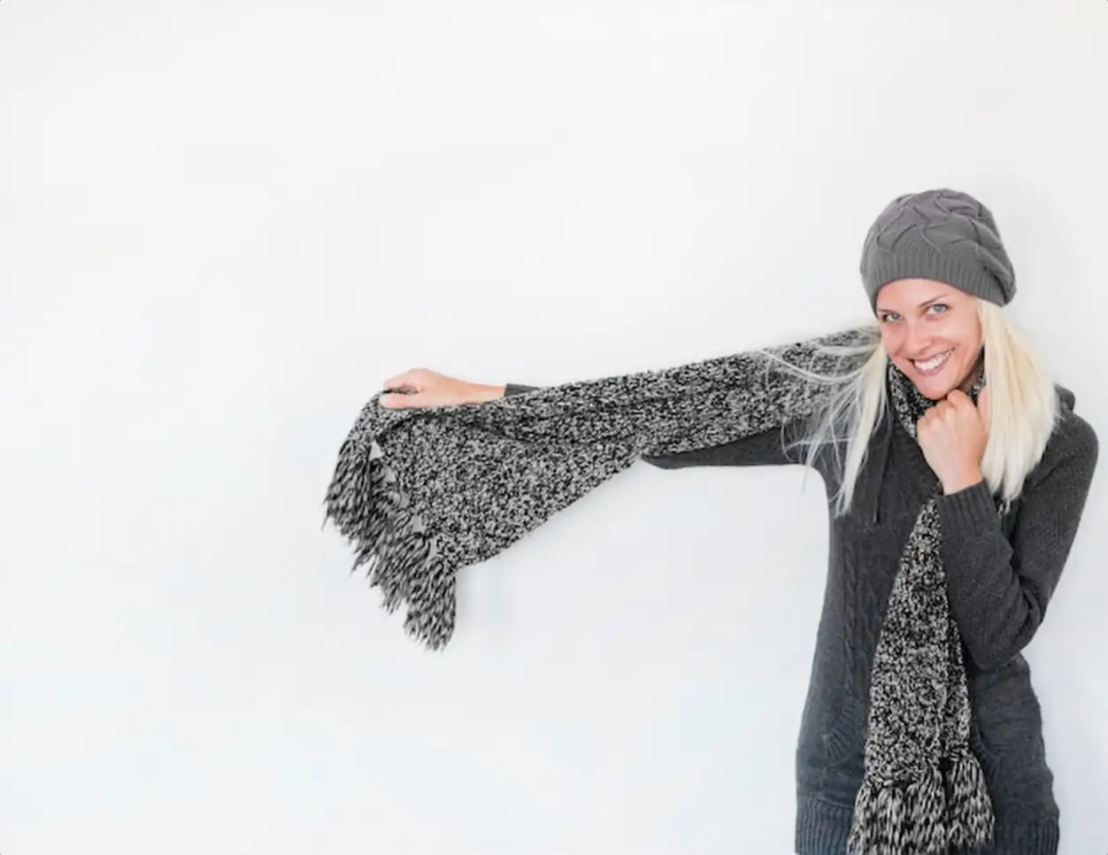 Cheerful woman showing scarf