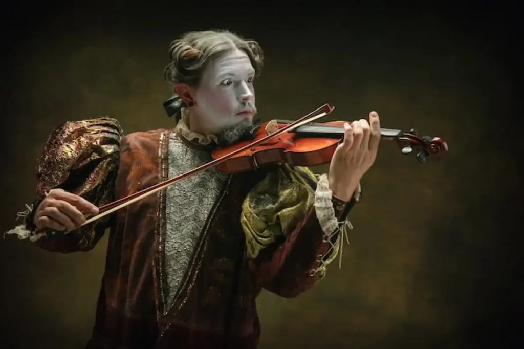 Playing violin Young man as Johann Bach isolated on dark green background Retro style