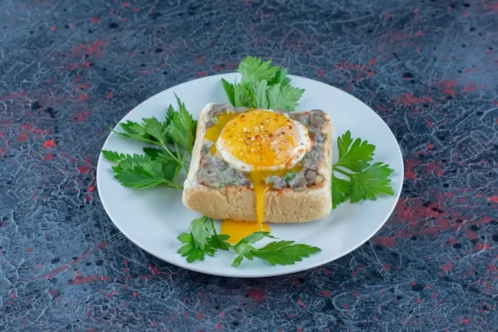 A blue plate of delicious toast with meat and vegetables.