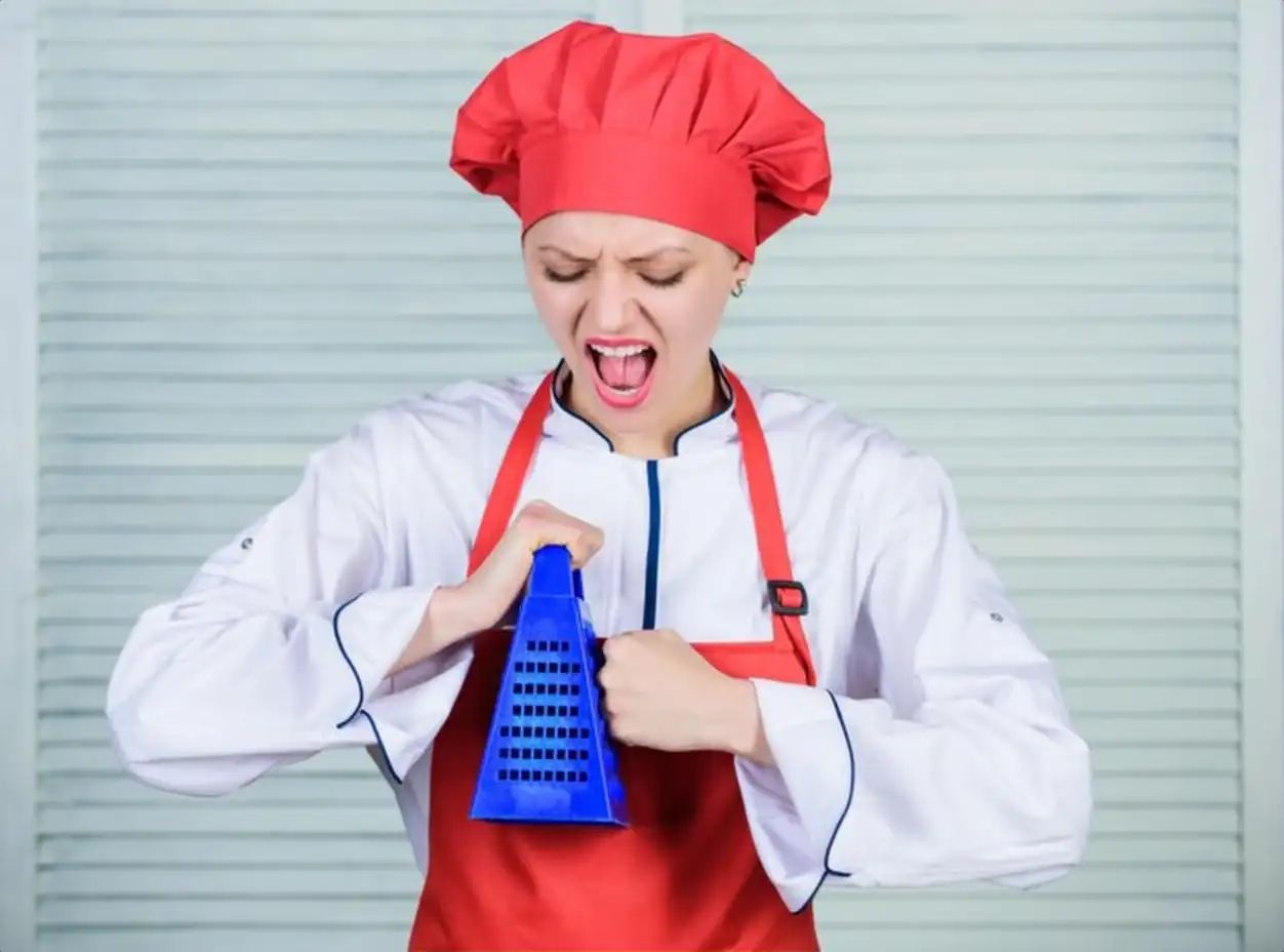 Lunch time Kitchen utensils culinary cuisine cook in restaurant uniform professional chef cooking in kitchen girl in apron and hat unhappy woman loves cooking food with grater