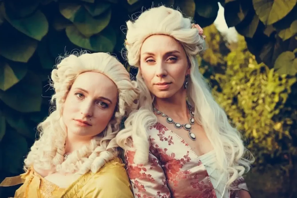 Portrait of two blonde woman dressed in historical Baroque clothes Luxurious medieval dress