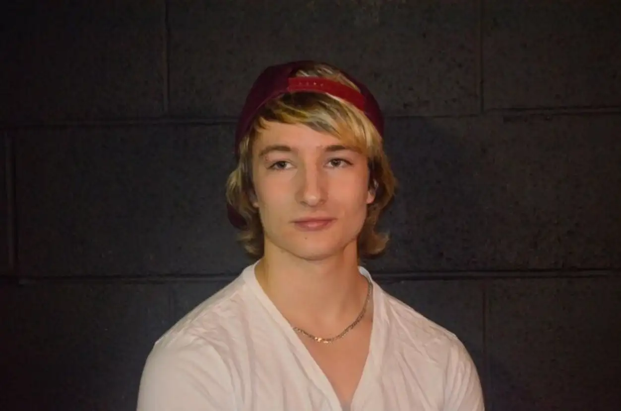 Close-up of man standing against wall