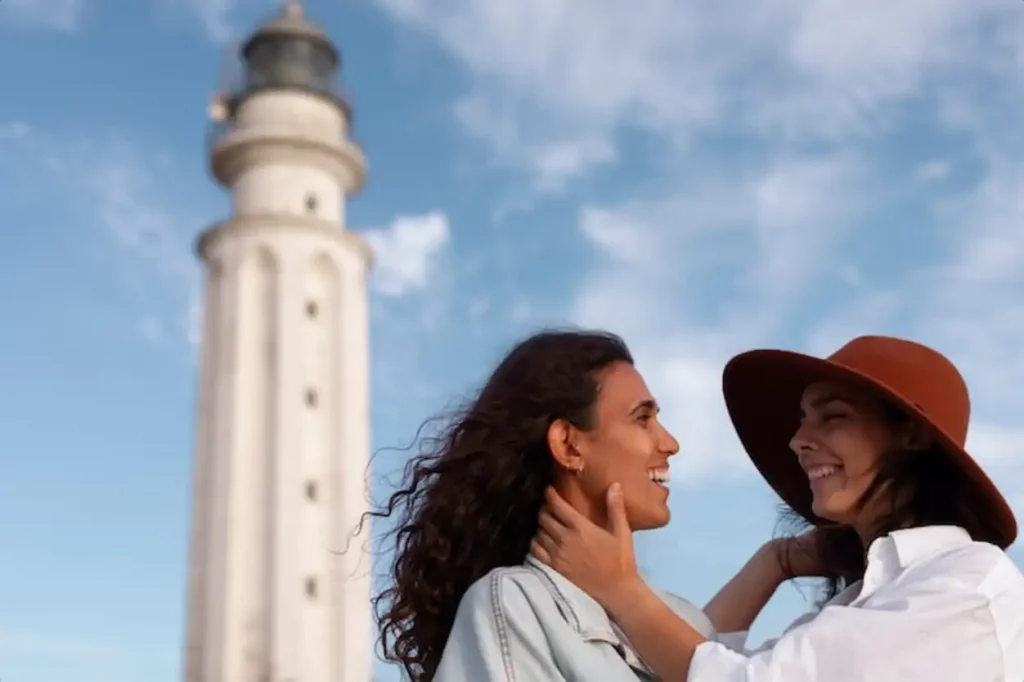 Medium shot women posing with lighthouse