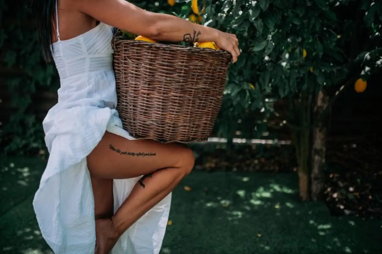 Midsection of woman standing by plants
