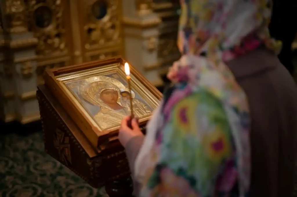 Woman praying in church for religious pilgrimage