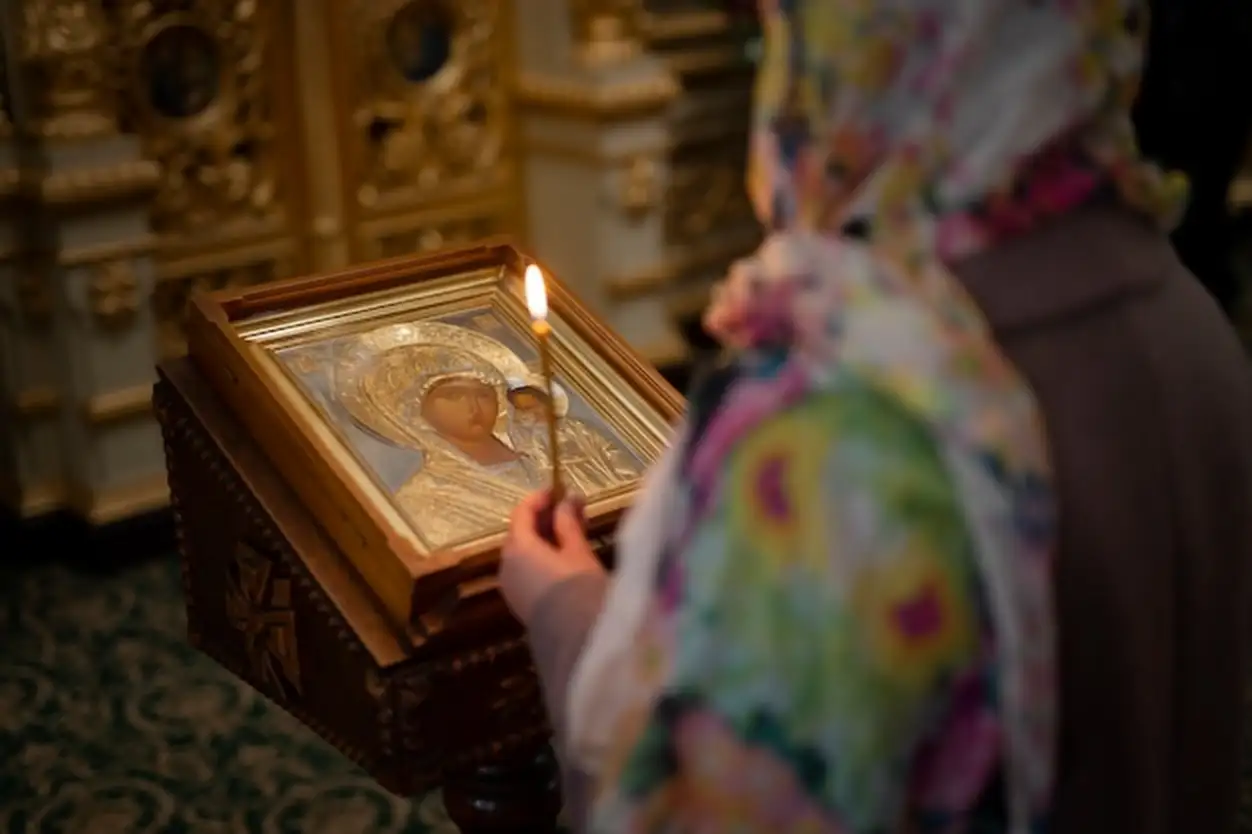 Woman praying in church for religious pilgrimage
