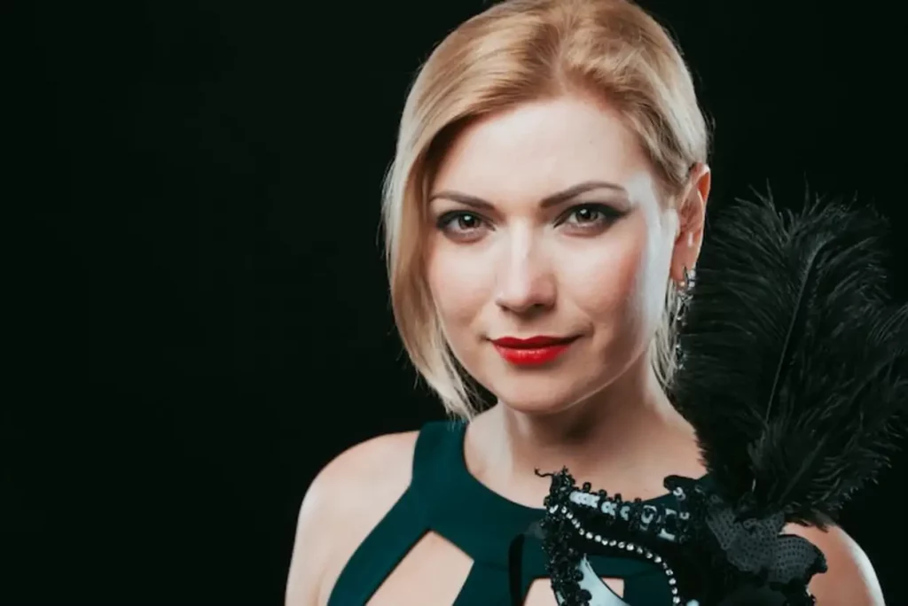 Blond woman with black carnival mask